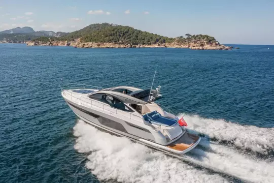 2026 Fairline Targa 50 Open yacht cruising near a scenic island.