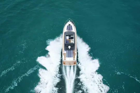 2026 Fairline Targa 50 Open yacht cruising on open sea, aerial view.
