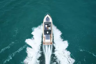 2026 Fairline Targa 50 Open yacht cruising on open sea, aerial view.