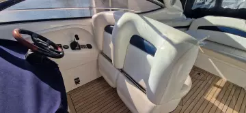 2003 Sunseeker Superhawk 34 interior with white seating and wooden flooring.