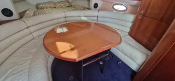 Luxurious interior of 2003 Sunseeker Superhawk 34 with elegant seating and wooden table.