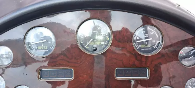 Dashboard of a 2003 Sunseeker Superhawk 34 with multiple gauges and wood finish.