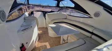 Luxurious interior of 2003 Sunseeker Superhawk 34 yacht with elegant seating and table.