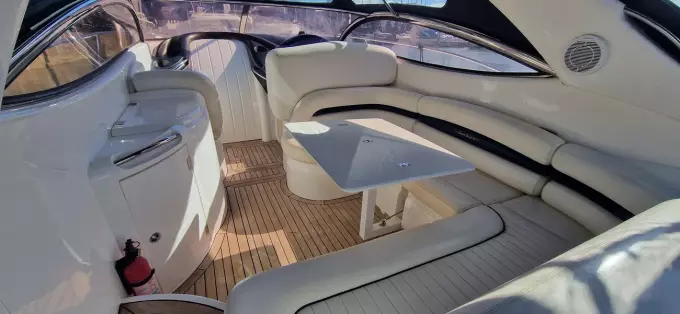 Luxurious interior of 2003 Sunseeker Superhawk 34 yacht with elegant seating and table.