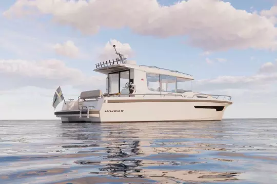 2026 Nimbus Commuter 12 boat on calm water under a partly cloudy sky.