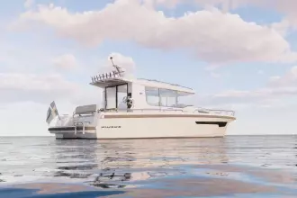 2026 Nimbus Commuter 12 boat on calm water under a partly cloudy sky.