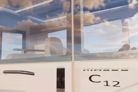 2026 Nimbus Commuter 12 with sleek design and modern interior, reflecting sky in windows.