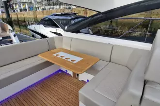 Luxurious seating area on 2024 Fairline Targa 45 Open yacht with elegant wood table.