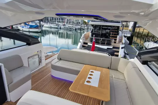 Luxurious 2024 Fairline Targa 45 Open yacht interior with elegant seating and wooden table.
