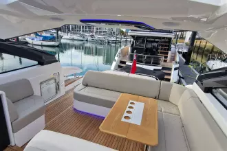 Luxurious 2024 Fairline Targa 45 Open yacht interior with elegant seating and wooden table.
