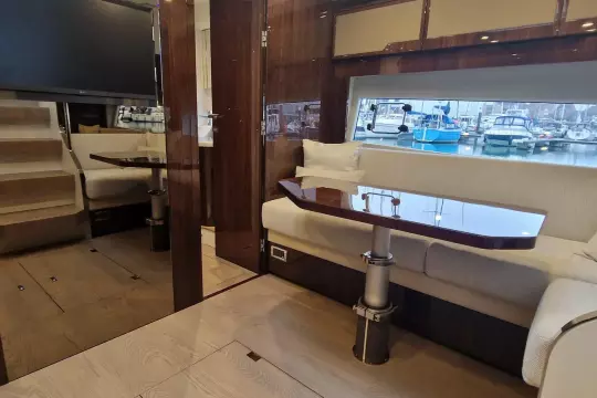 Luxurious interior of 2024 Fairline Targa 45 Open yacht with elegant seating and marina view.