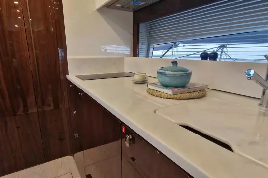 Luxurious kitchen interior of 2024 Fairline Targa 45 Open yacht, featuring sleek countertops.
