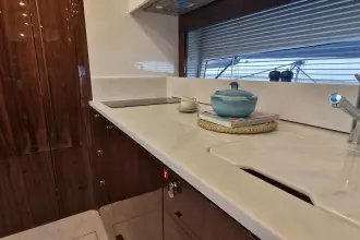 Luxurious kitchen interior of 2024 Fairline Targa 45 Open yacht, featuring sleek countertops.