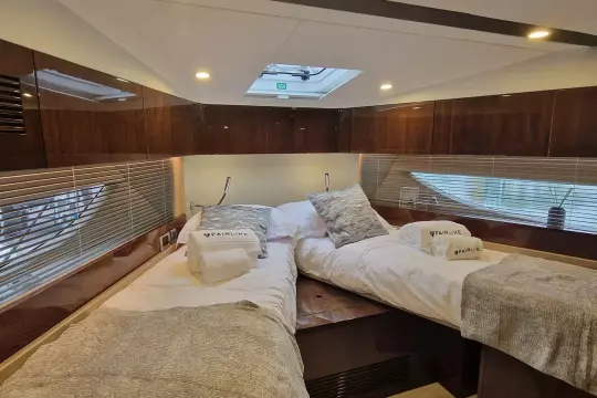 Luxurious cabin interior of 2024 Fairline Targa 45 Open yacht with twin beds.