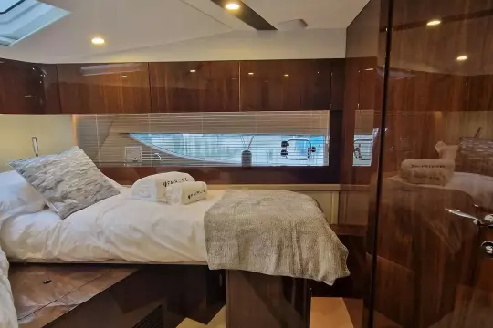 Luxurious interior of 2024 Fairline Targa 45 Open yacht cabin with elegant wood finishes.