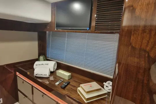 Luxurious interior of 2024 Fairline Targa 45 Open yacht with TV and elegant wood finish.
