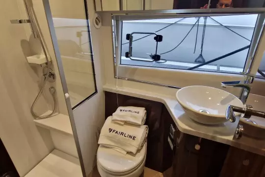 Luxurious bathroom in 2024 Fairline Targa 45 Open yacht with modern fixtures and branded towels.