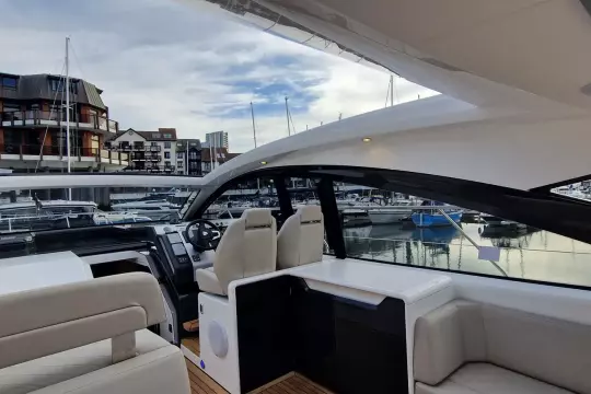 2024 Fairline Targa 45 Open yacht interior with modern seating and marina view.