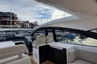 2024 Fairline Targa 45 Open yacht interior with modern seating and marina view.