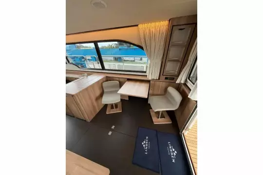 Interior of 2025 Linssen 45 SL Sedan yacht with modern seating and large windows.