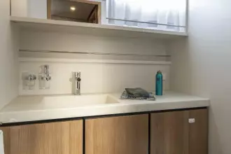 Modern bathroom interior of 2025 Linssen 45 SL Sedan yacht, featuring sleek sink and cabinetry.