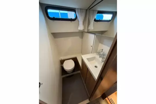 Bathroom interior of 2025 Linssen 45 SL Sedan yacht, featuring toilet and sink.