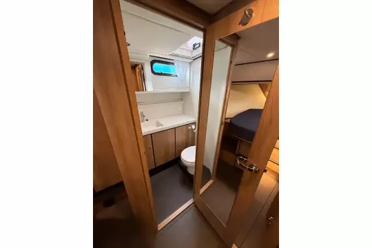Interior of 2025 Linssen 45 SL Sedan yacht, featuring a modern bathroom and cozy cabin.