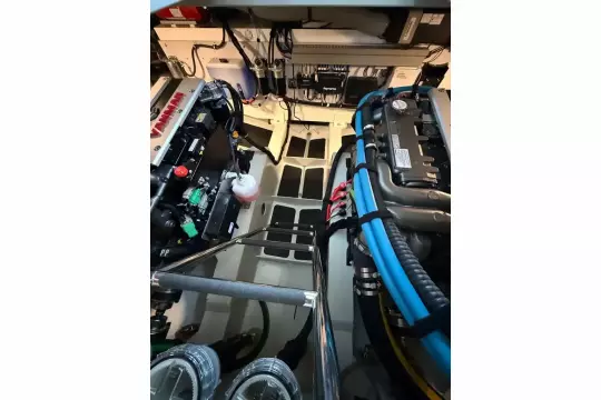 Engine room of 2025 Linssen 45 SL Sedan yacht, showcasing advanced machinery and wiring.