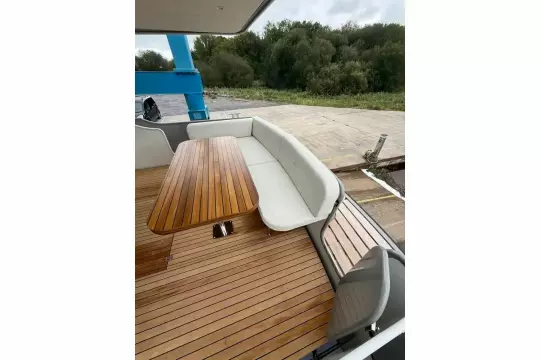 2025 Linssen 45 SL Sedan yacht with elegant wooden deck and seating area.