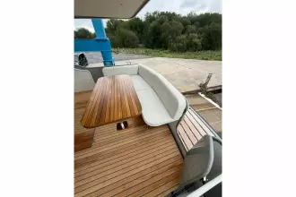 2025 Linssen 45 SL Sedan yacht with elegant wooden deck and seating area.