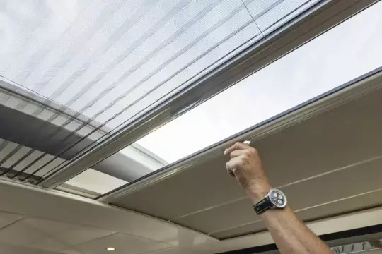 Hand adjusting sunroof on 2025 Linssen 45 SL Sedan yacht.