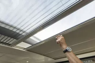 Hand adjusting sunroof on 2025 Linssen 45 SL Sedan yacht.