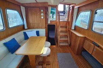 Interior of 2008 Linssen Grand Sturdy 380 AC yacht with wooden furnishings and seating area.