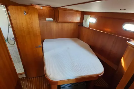 Cozy cabin interior of 2008 Linssen Grand Sturdy 380 AC yacht with wooden finish.