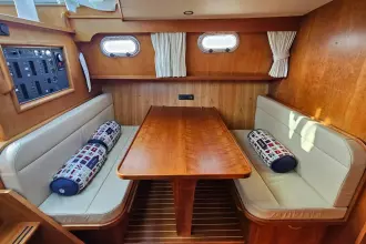 Interior of 2008 Linssen Grand Sturdy 380 AC with wooden dining area and cushioned seating.