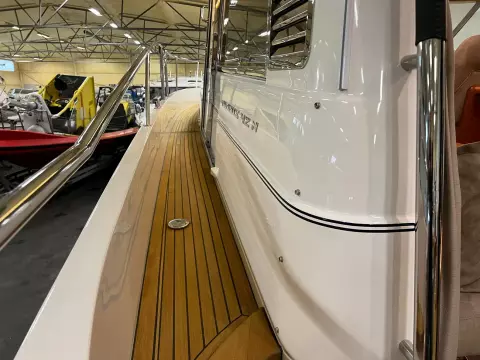 2008 Nimbus 42 Nova yacht with teak deck and sleek white exterior in a showroom.