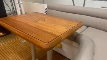 Luxurious wooden table and seating area on a 2008 Nimbus 42 Nova yacht.