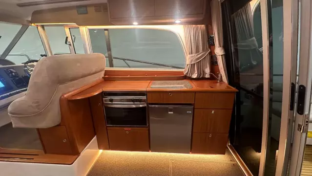 Luxurious 2008 Nimbus 42 Nova yacht interior with modern kitchen and elegant wood finish.