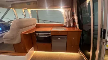 Luxurious 2008 Nimbus 42 Nova yacht interior with modern kitchen and elegant wood finish.
