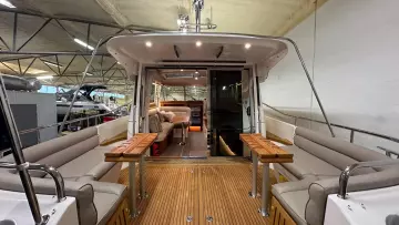 Interior view of 2008 Nimbus 42 Nova yacht with seating and wooden deck.