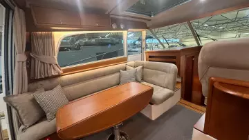 Luxurious interior of 2008 Nimbus 42 Nova yacht with cozy seating and elegant wood finishes.