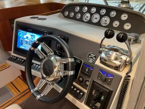 2008 Nimbus 42 Nova boat dashboard with steering wheel, controls, and navigation screen.