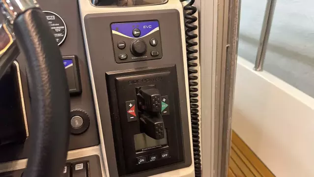 Control panel of a 2008 Nimbus 42 Nova boat with steering wheel and switches.