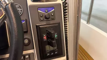 Control panel of a 2008 Nimbus 42 Nova boat with steering wheel and switches.