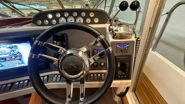 Steering wheel and controls of a 2008 Nimbus 42 Nova boat cockpit.