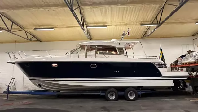 Nimbus 42 Nova 2008 boat in indoor storage, side view, on a trailer.