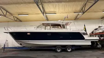 Nimbus 42 Nova 2008 boat in indoor storage, side view, on a trailer.