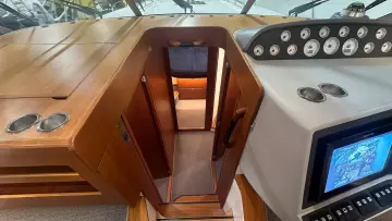 Interior view of a 2008 Nimbus 42 Nova boat, featuring a wooden cabin entrance.